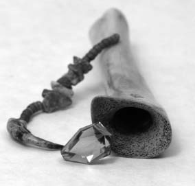 picture of a shamanic extraction tube made from deer bone, stones, and crystal